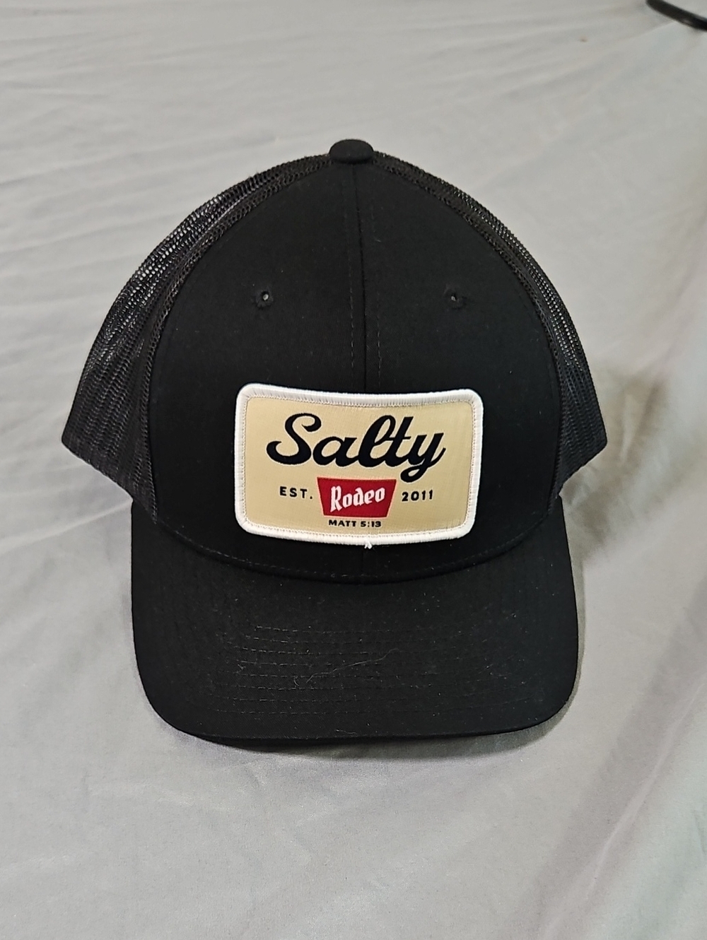 The Classic Black Mesh Trucker Cap with Salty Rodeo Patch